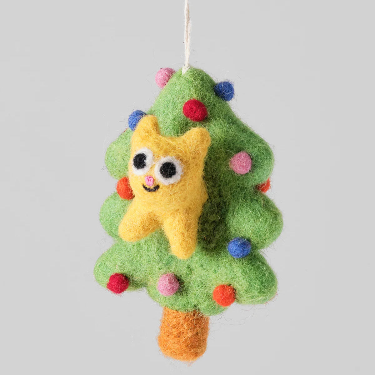 Felted Christmas tree ornament with a smiling yellow star on a gray background