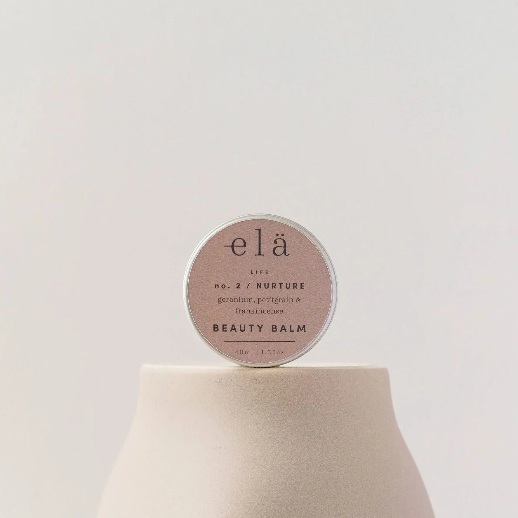 elä Life No.2 Nurture Beauty Balm in a round tin.  Contains geranium, petitgrain & frankincense. 40ml/1.35oz.
