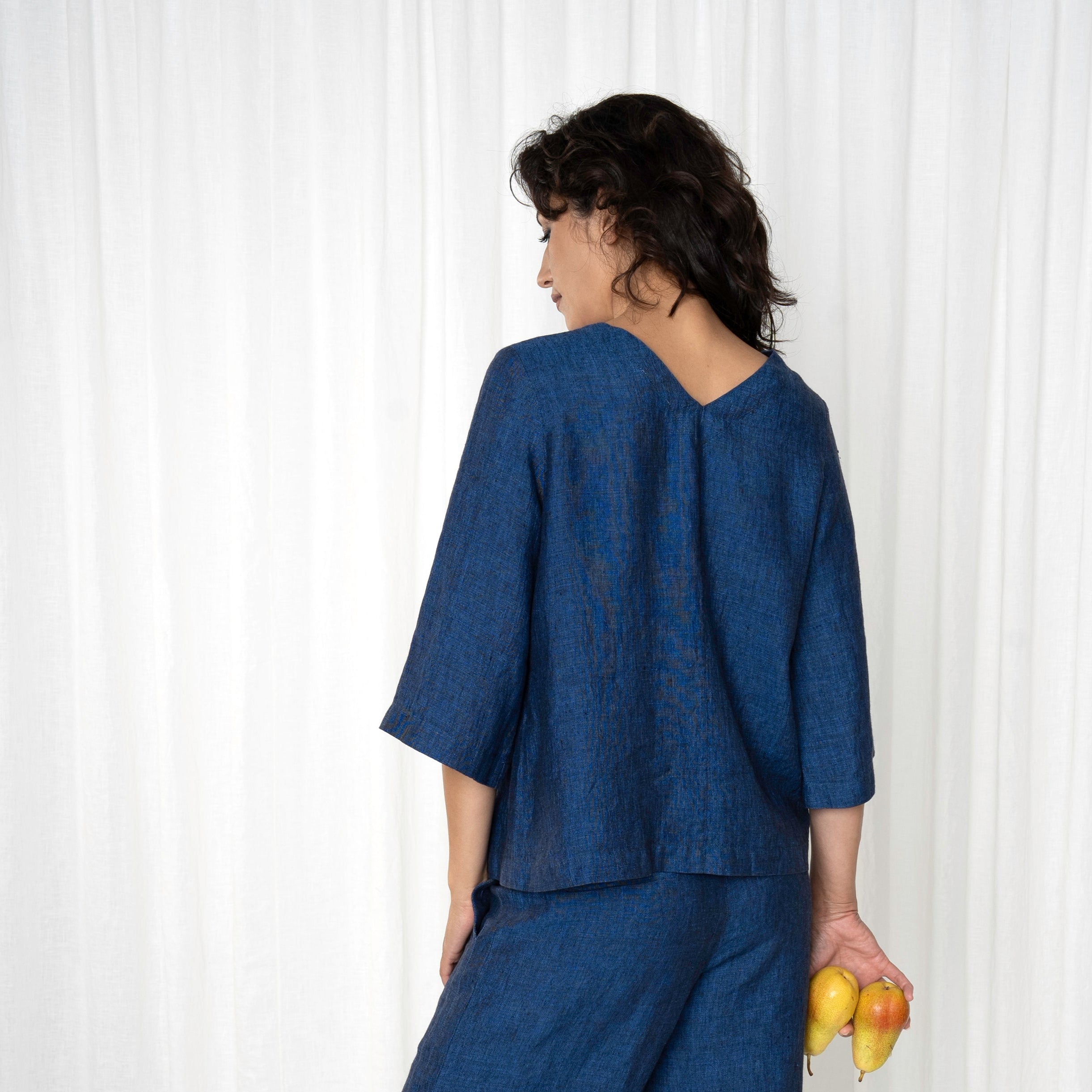 Deep blue linen top and wide-leg pants set.  The three-quarter sleeve top features a V-neck back.