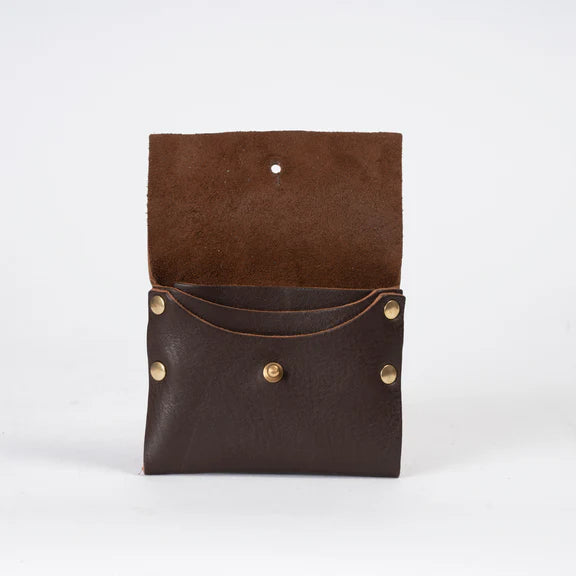 Dark brown leather wallet open, showing interior pockets and brass studs.