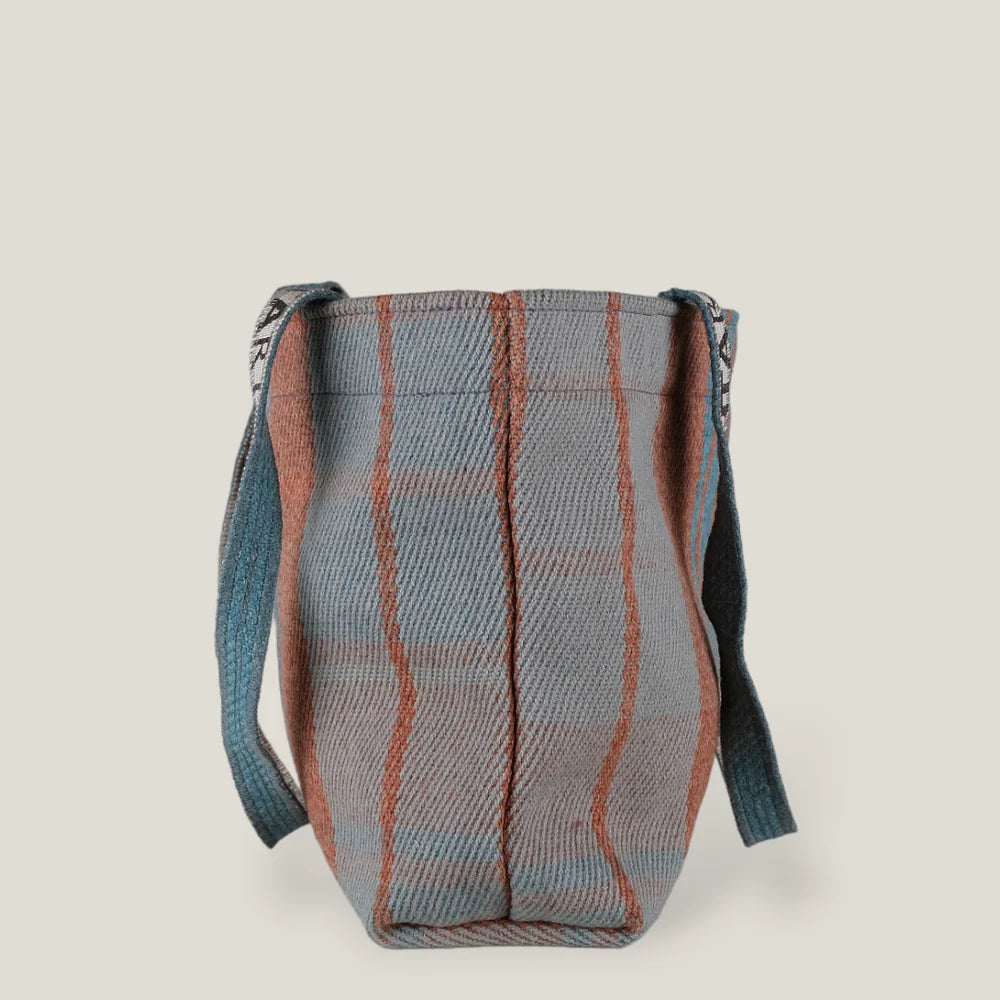 Blue and terracotta plaid tote bag with long straps.