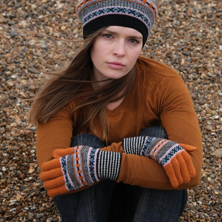 Fair isle patterned gloves and matching beret.  Warm orange and black knitwear.