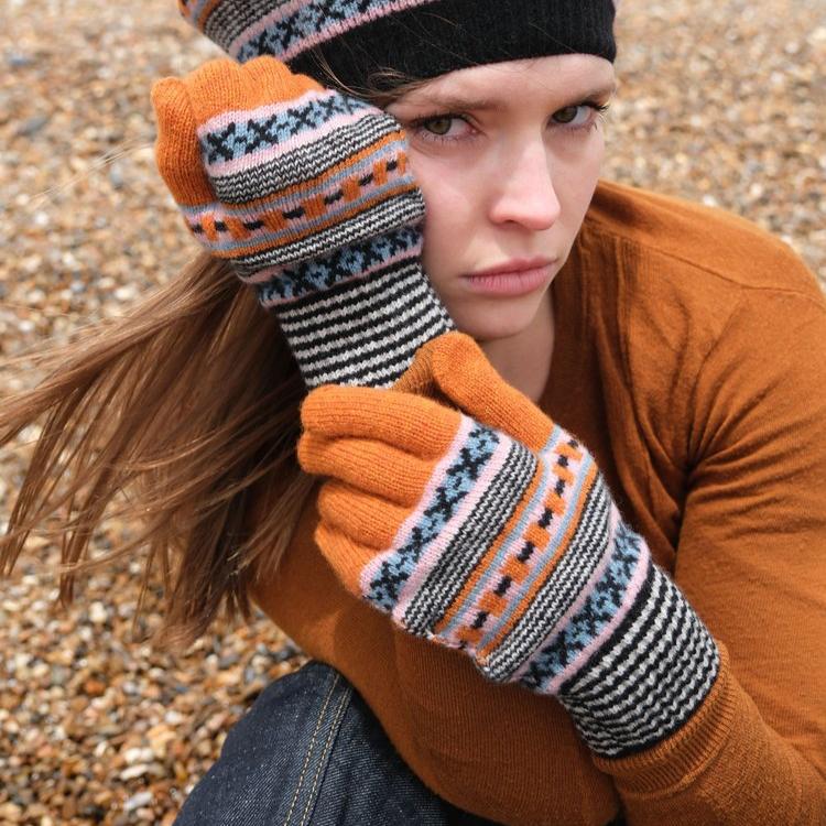 Orange gloves with a Fair Isle-style pattern in black, grey, and pale blue.
