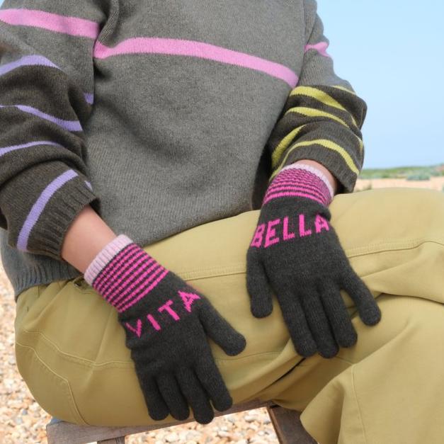 Pair of dark green cashmere gloves with pink horizontal stripes and "Bella" and "Vita" lettering.