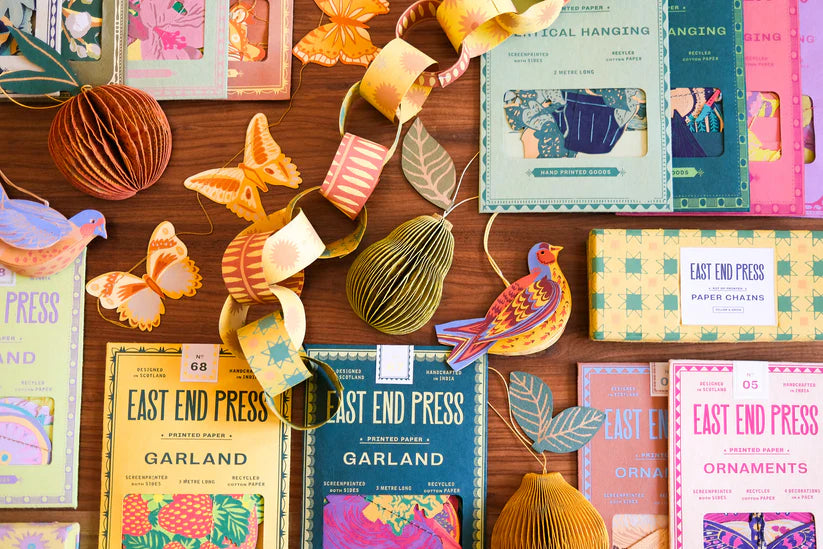 Assortment of East End Press paper garlands, ornaments, and chains featuring birds, butterflies, and pears in vintage-style
