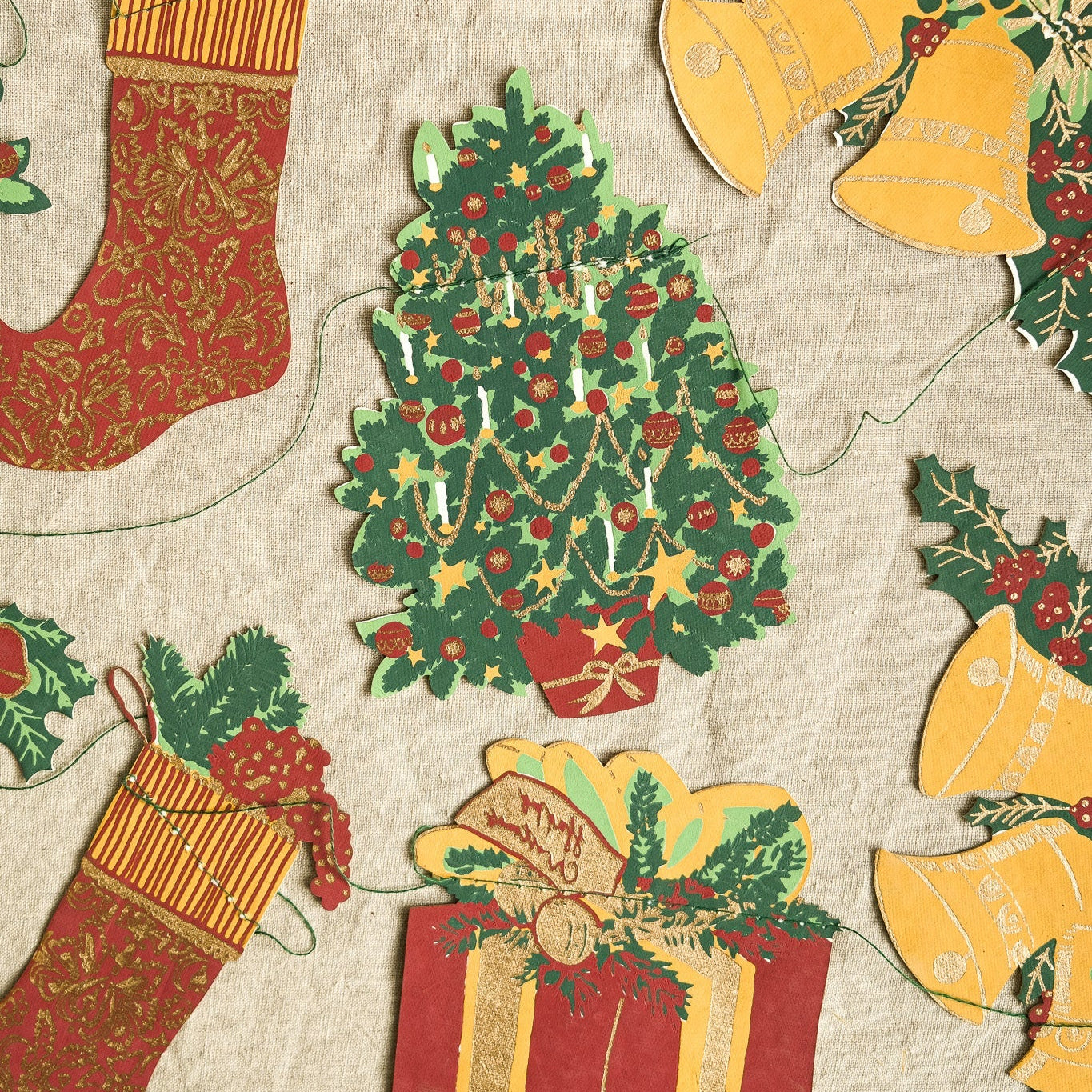 Vintage-style Christmas decorations including stockings, a tree, and bells on a textured background.