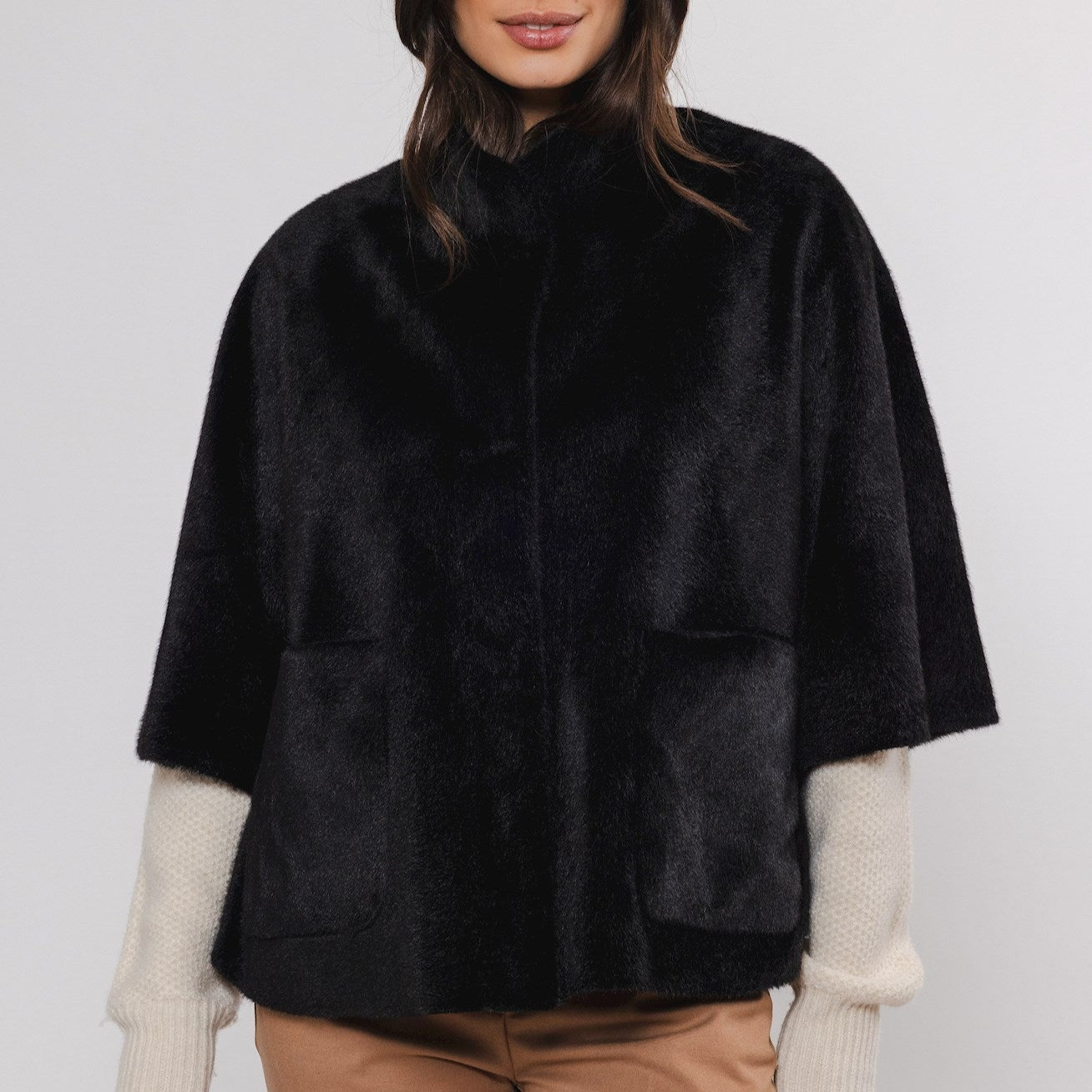 Black short-sleeved, cropped jacket with patch pockets.  Soft, plush fabric.