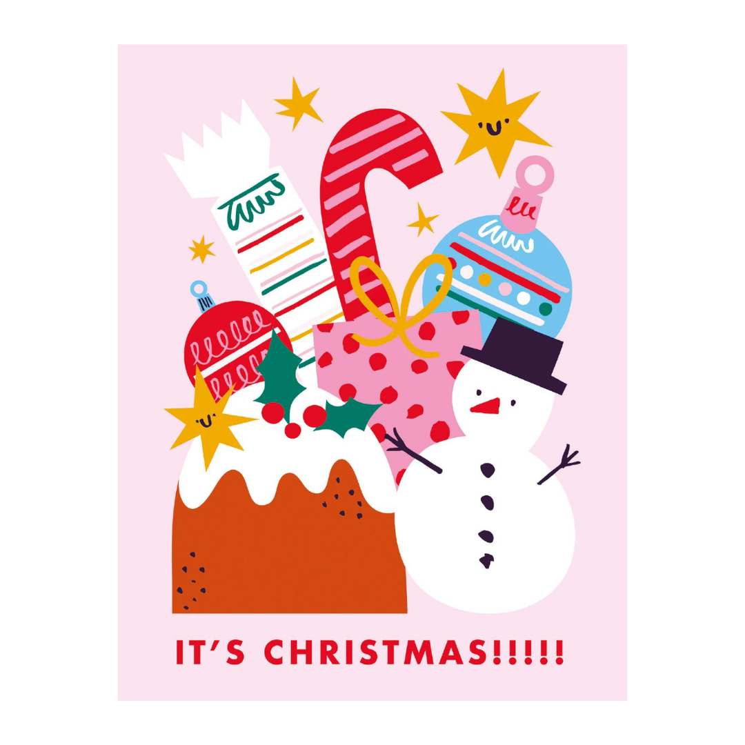 A festive Christmas greeting card design with the text 'IT'S CHRISTMAS!!!!!' at the bottom. The illustration features a snowman wearing a blue hat, a large red-and-white candy cane, a pink polka-dot sack, a brown pudding with white icing, and gold stars on a light pink background.
