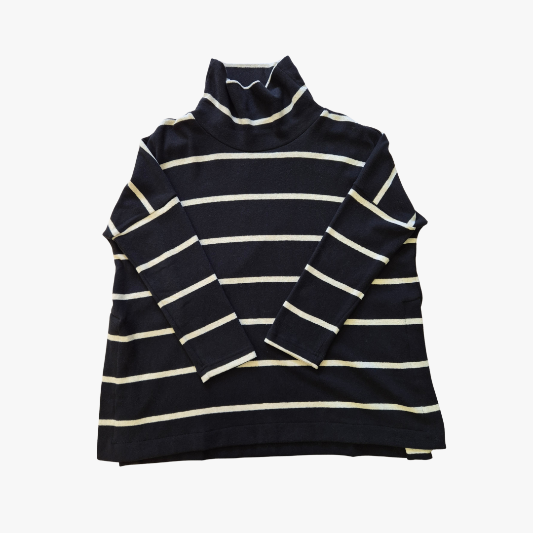 A navy blue long-sleeve turtleneck sweater with horizontal cream stripes, laid flat against a light gray background.