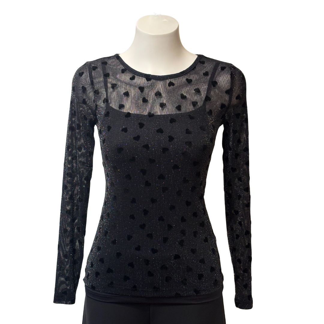 Black long-sleeve top with sheer heart patterns on a mannequin against a white background
