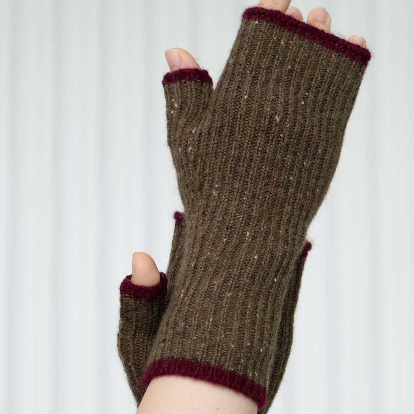 Brown fingerless gloves with purple trim on a white background