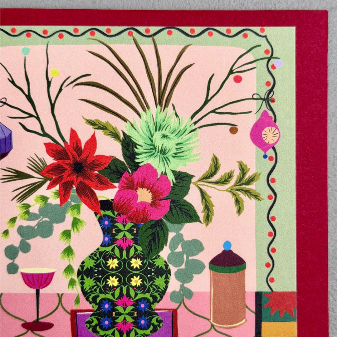 A square art print or card featuring a colorful floral arrangement in a patterned green vase, set against a pink background with a red border and decorative botanical elements.