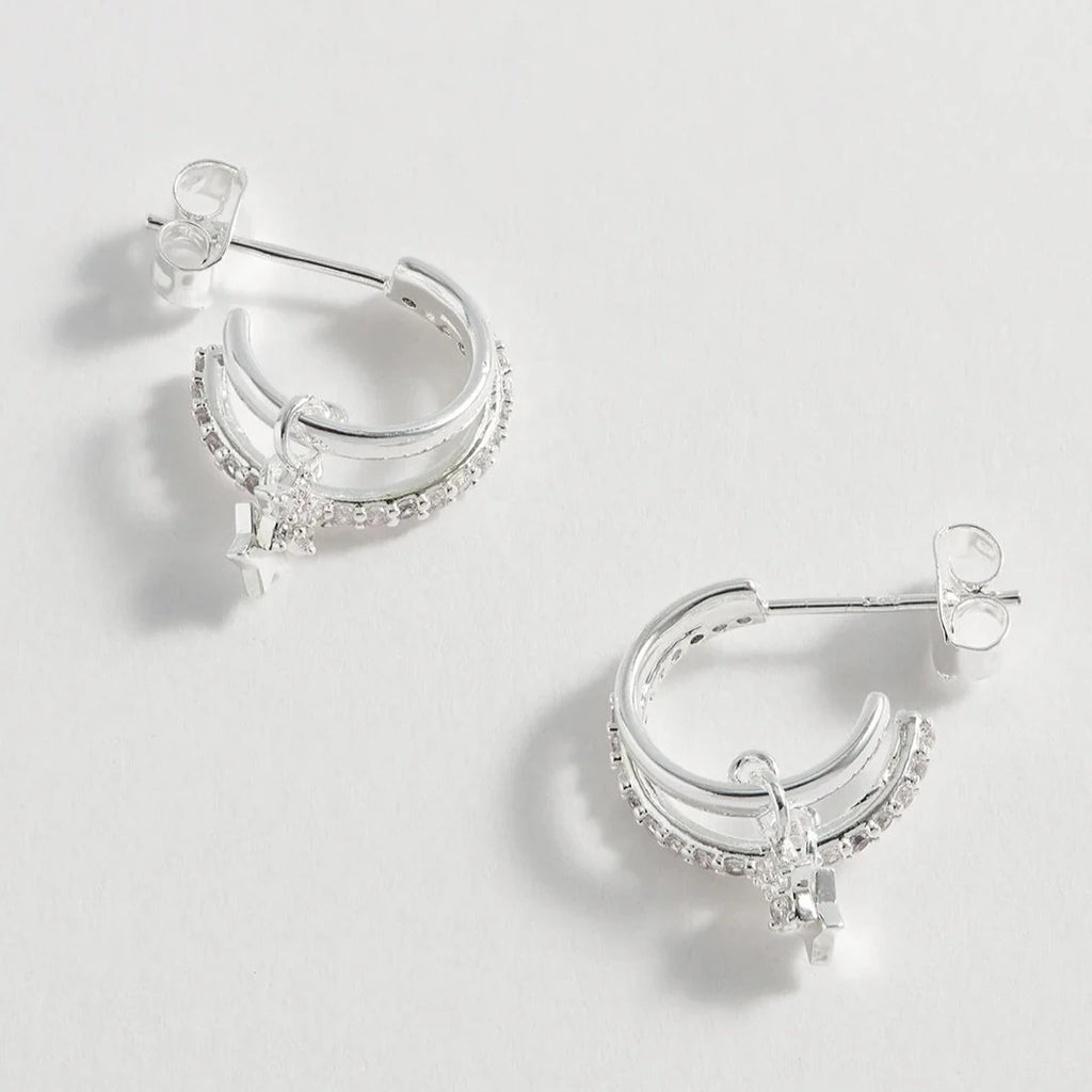 Silver double hoop earrings with small star charms and clear cubic zirconia accents.