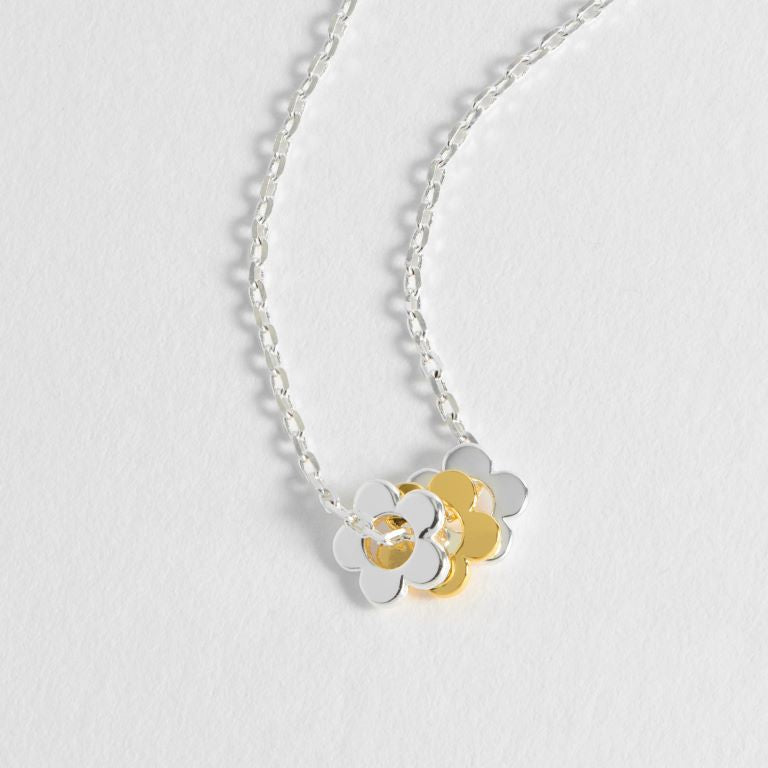 Silver chain necklace with three overlapping flower charms; two silver, one gold.