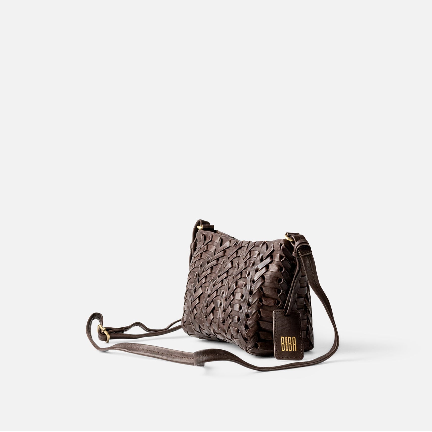 A dark brown woven leather shoulder bag with a long strap and a small gold-tone logo plaque, photographed on a clean white background.
