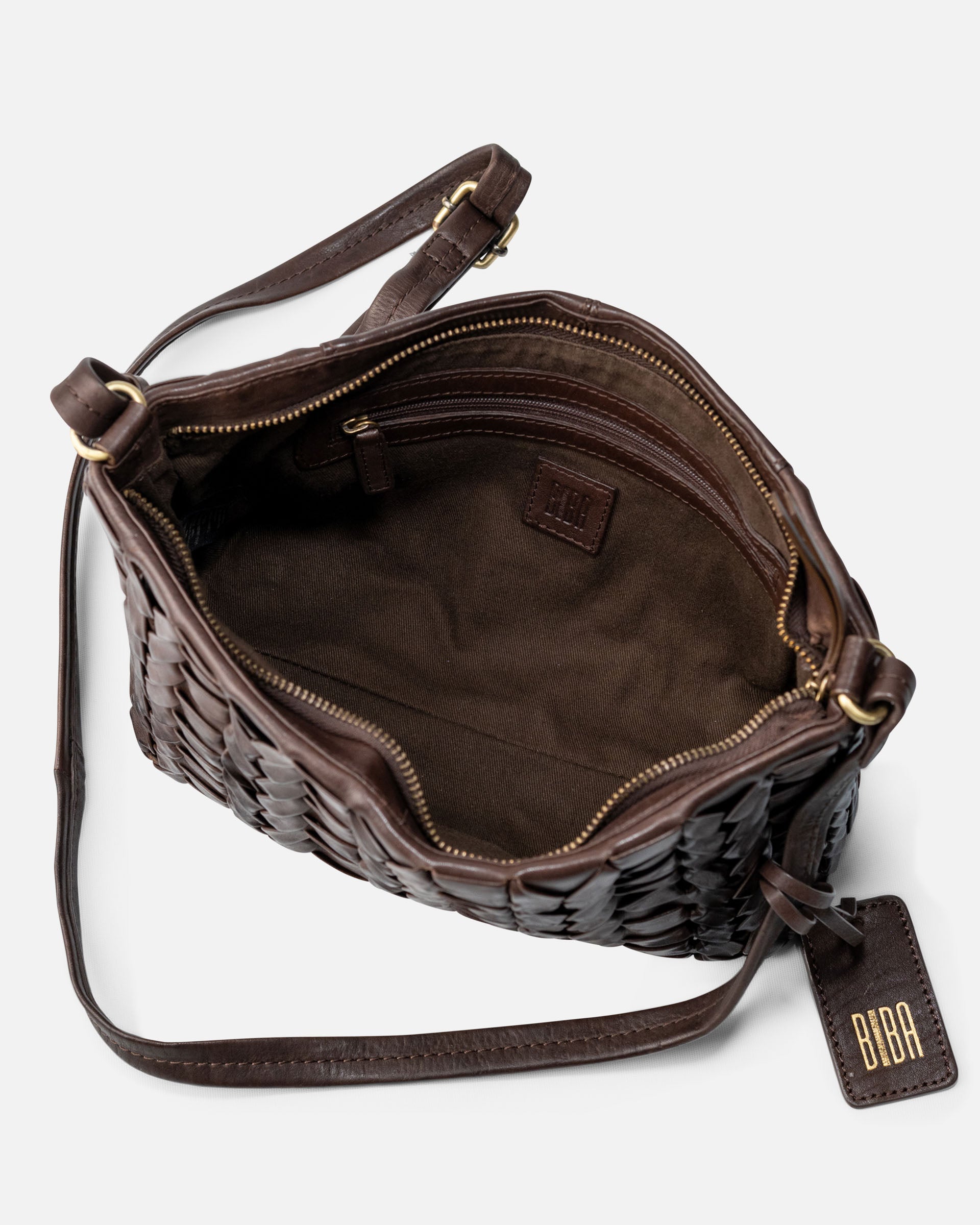 A dark brown woven leather shoulder bag shown open, displaying its interior lining and compartments. A matching leather hangtag with gold lettering reading 'BOBA' is attached on the right side, set against a clean, light gray background.