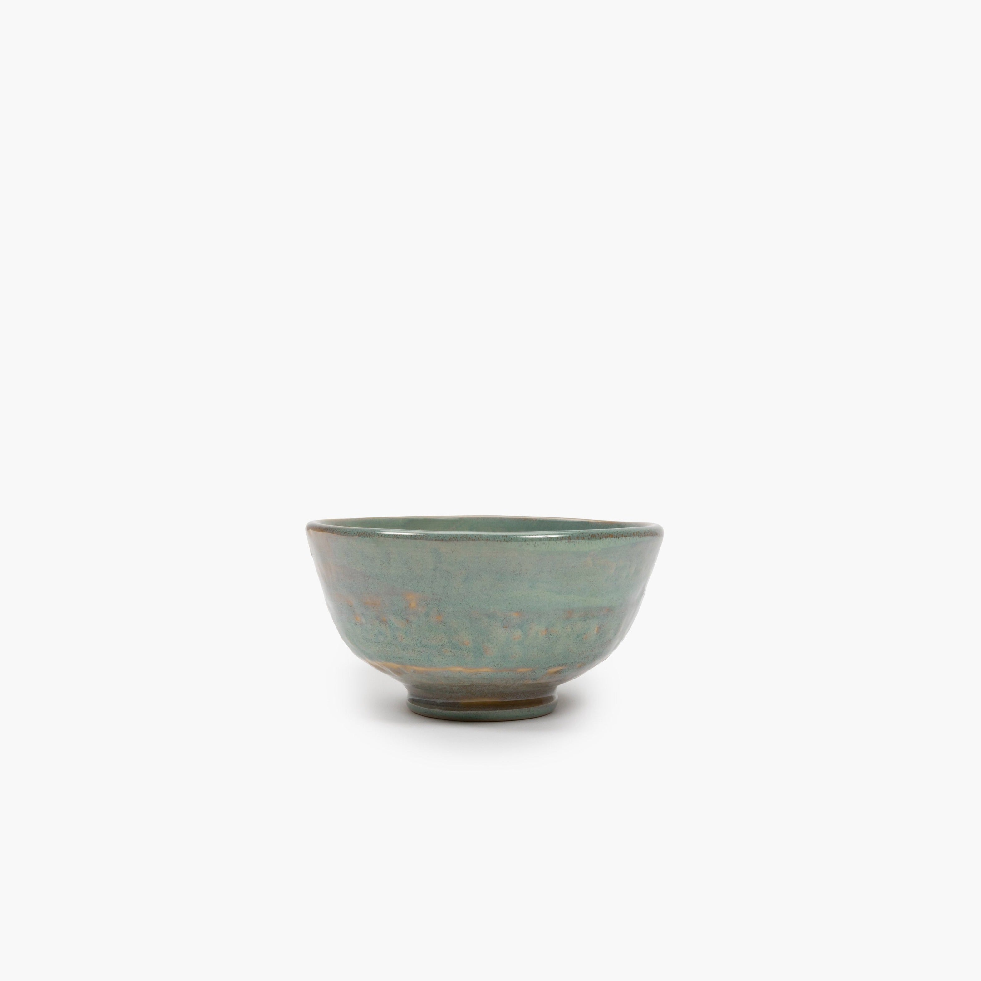 Small, round ceramic bowl with a teal glaze and subtle gold accents.