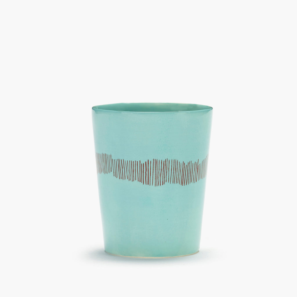 azure tea cup, with red organic stripes, from the FEAST collection, designed by British-Israeli chef Yotam Ottolenghi, for Belgian design brand Serax.