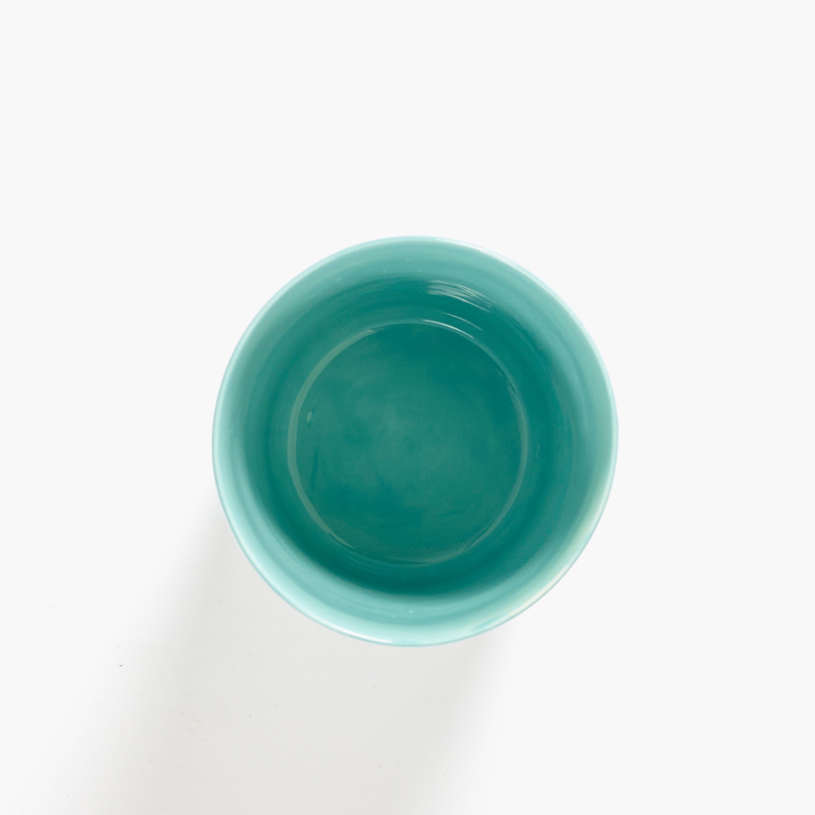 Empty light teal ceramic bowl viewed from above.