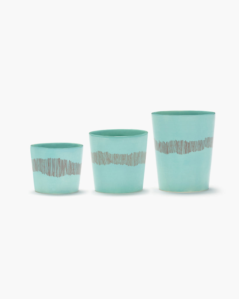 various sized azure tea cups, with red organic stripes, from the FEAST collection, designed by British-Israeli chef Yotam Ottolenghi, for Belgian design brand Serax.