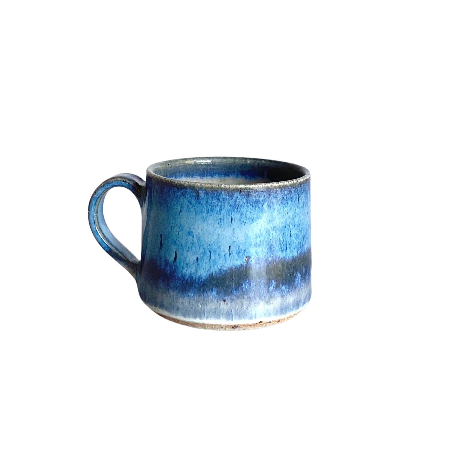 Hand-thrown ceramic mug with a blue and dark-blue glaze, featuring a slightly irregular rim and a sturdy handle.