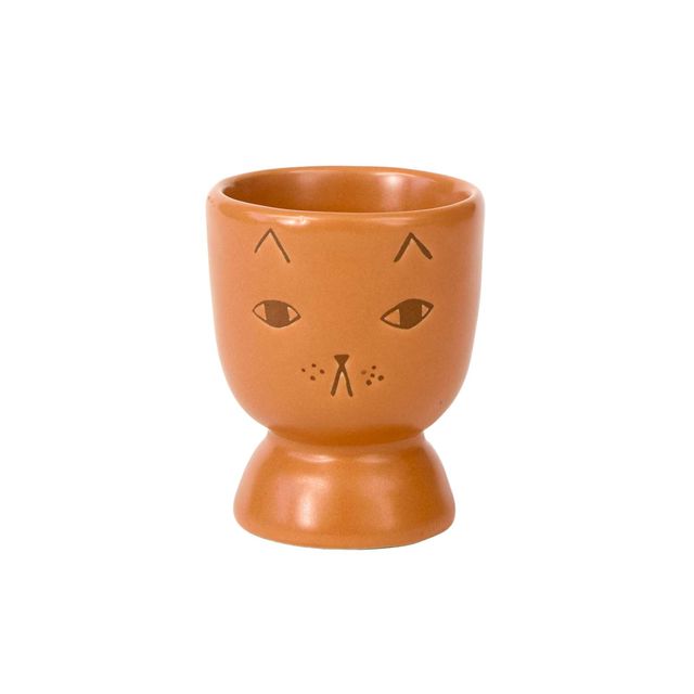 Ceramic cup with cat face design on a white background