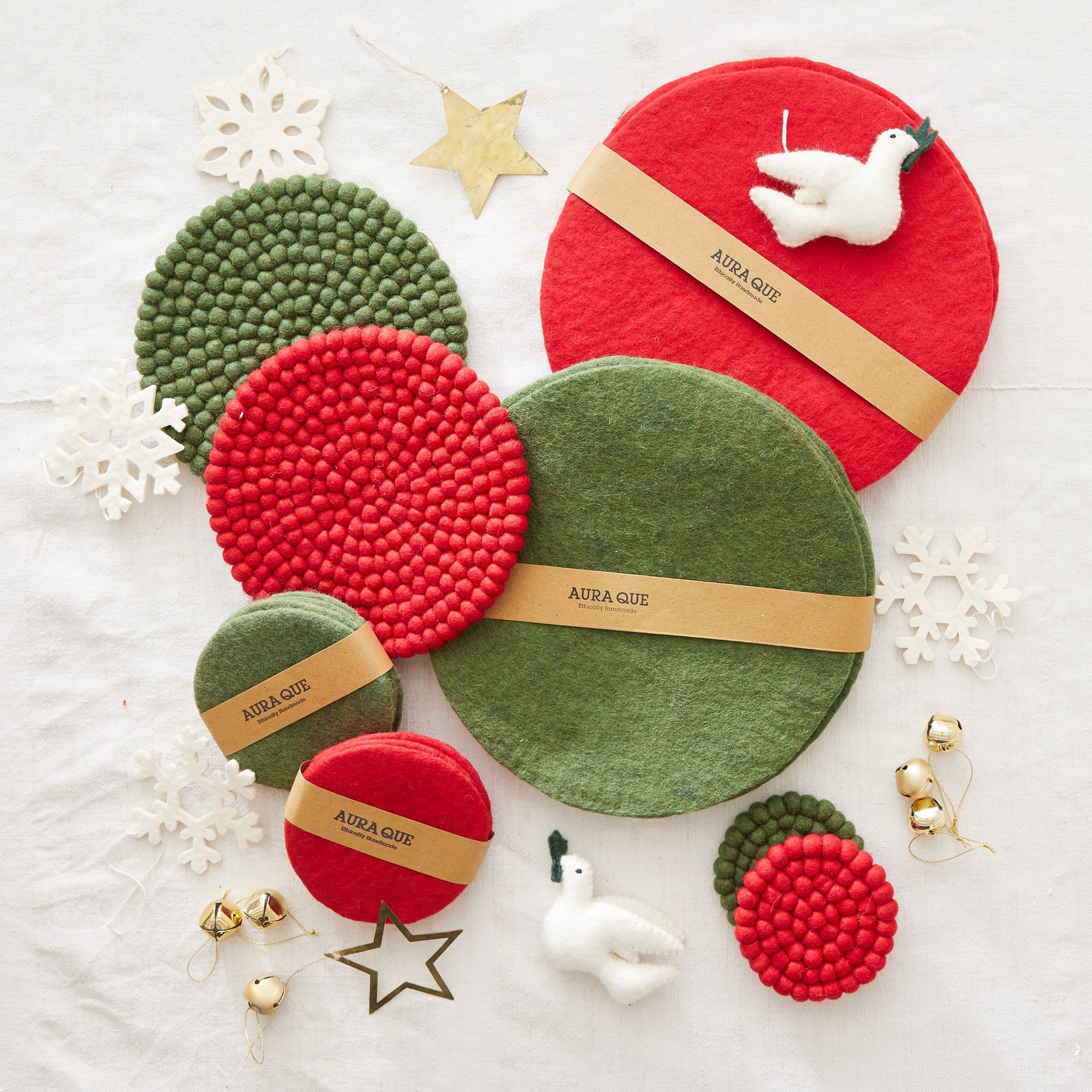 Set of ethically handmade felt coasters in red and green, featuring a textured pom-pom design.