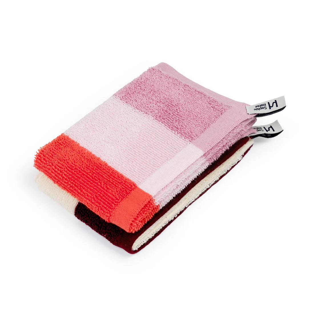 Set of three colorful washcloths with a brand tag on a white background