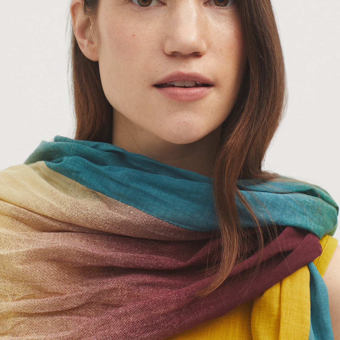 Multicolored ombre scarf in teal, beige, and burgundy.