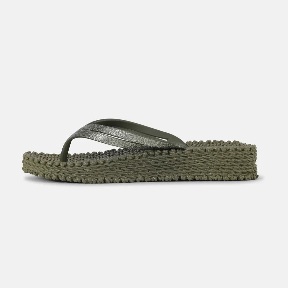 Olive green flip-flop with a textured sole and silver glitter strap.