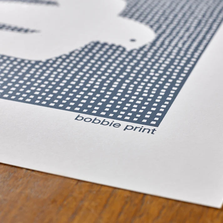 Blue and white abstract print featuring a dotted pattern and stylized shapes, signed "bobbie print".