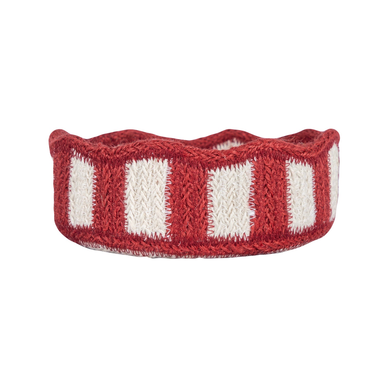 Red and white striped knitted headband on a white background