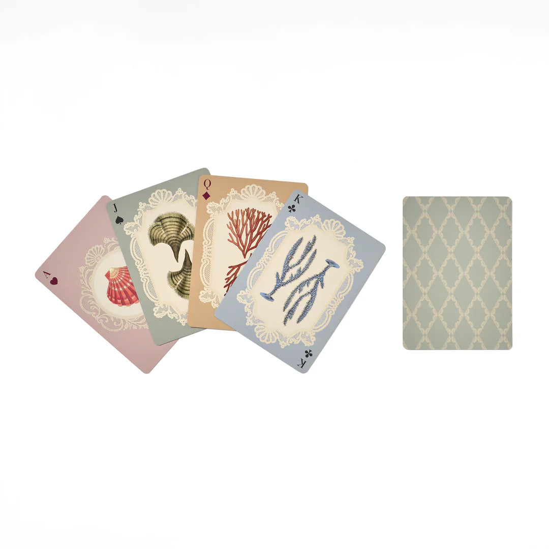 Set of playing cards with nature-themed designs on a white background
