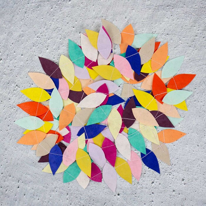 Colorful leaf-shaped rug on a textured gray surface