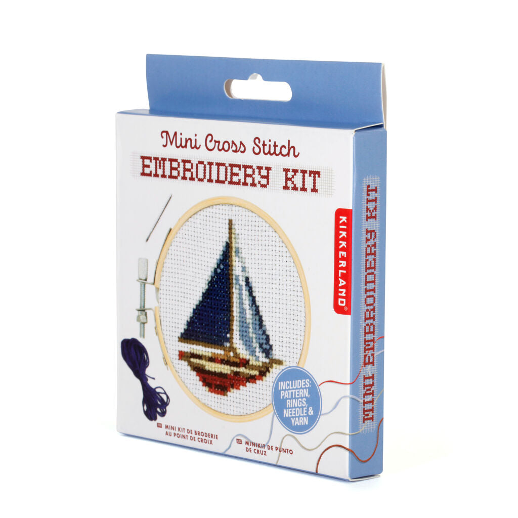 Mini cross-stitch embroidery kit depicting a sailboat; includes pattern, rings, needle, and yarn.