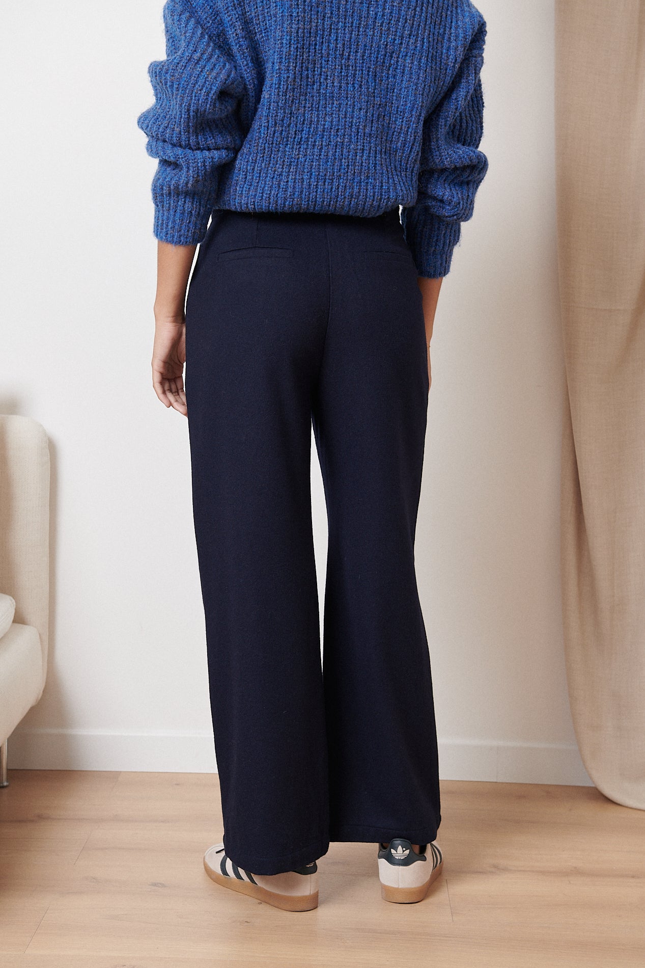 Dark navy blue wide-leg trousers, high-waisted with a clean, simple design.