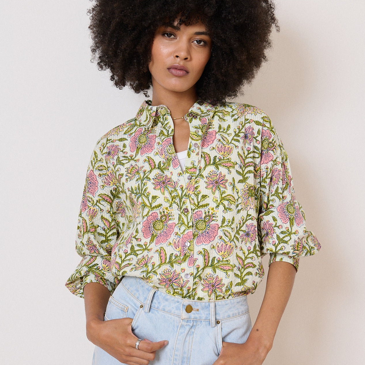 Off-white floral button-up shirt with pink and green flowers.  Three-quarter sleeves, relaxed fit.