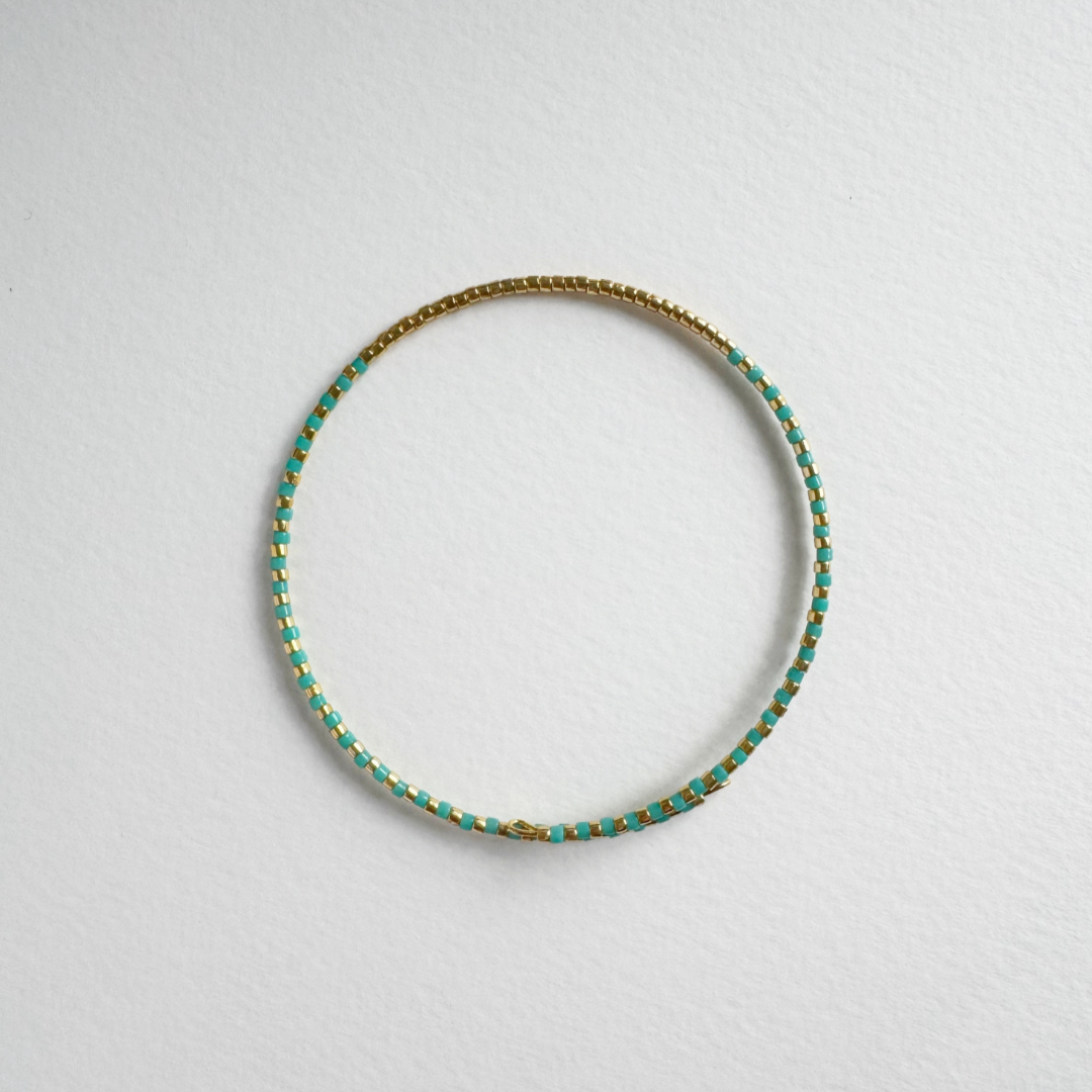 Teal and gold beaded bangle bracelet.
