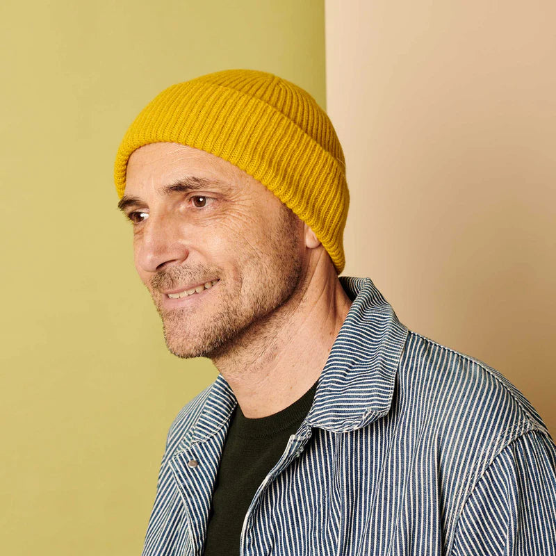 Mustard yellow ribbed knit beanie.