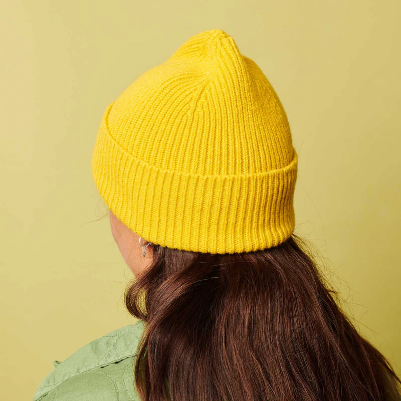 Mustard yellow ribbed knit beanie.