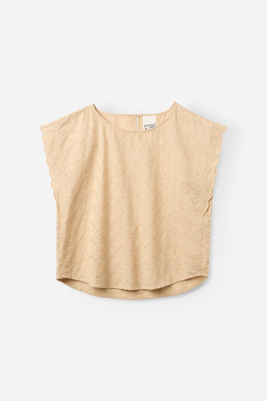 women wearing a cream embroidered blouse