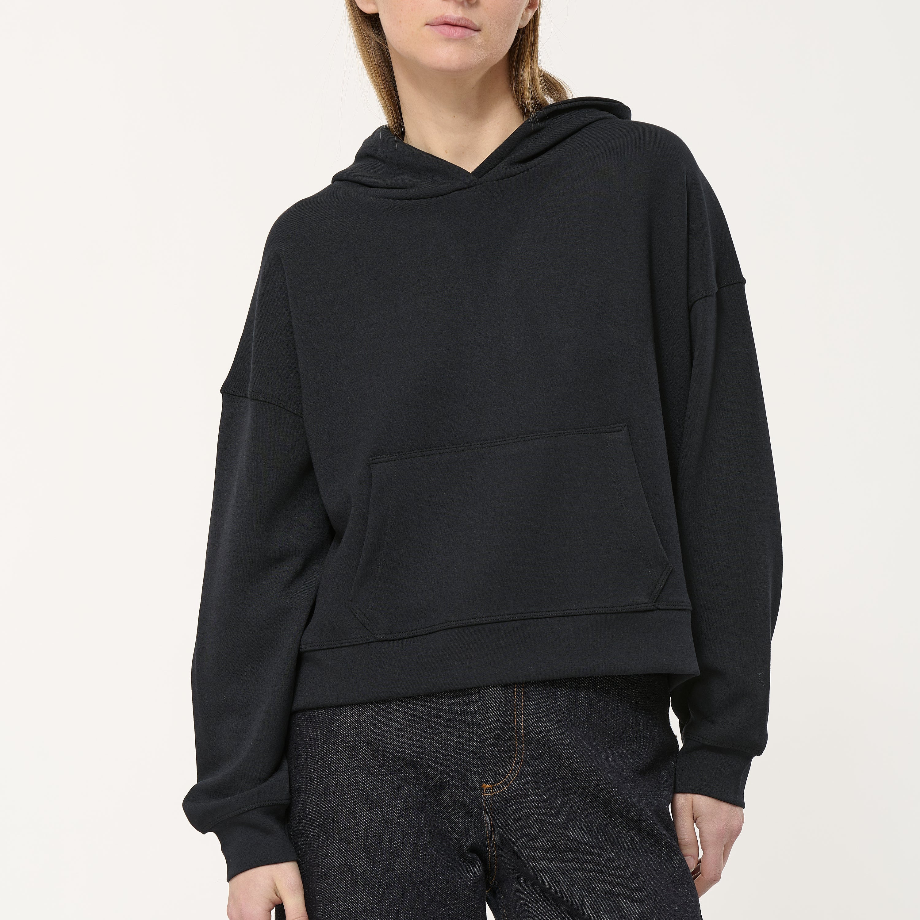 Black hooded sweatshirt with kangaroo pocket, long sleeves, and a relaxed fit.
