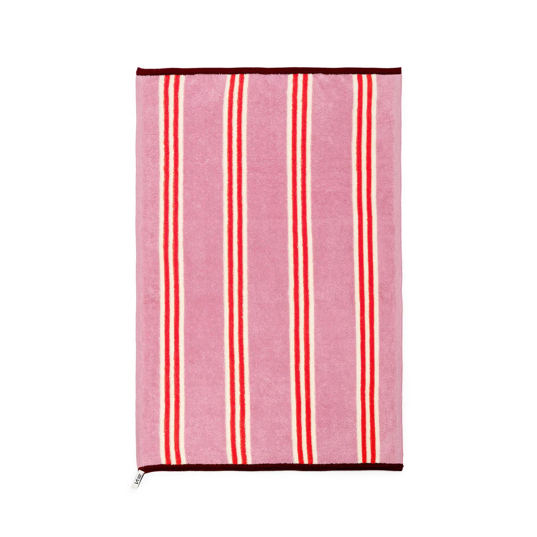 Striped towel with red and white stripes on a pink background