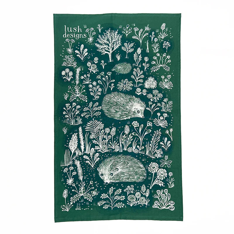 Dark green tea towel with white illustrated hedgehogs and wildflowers.