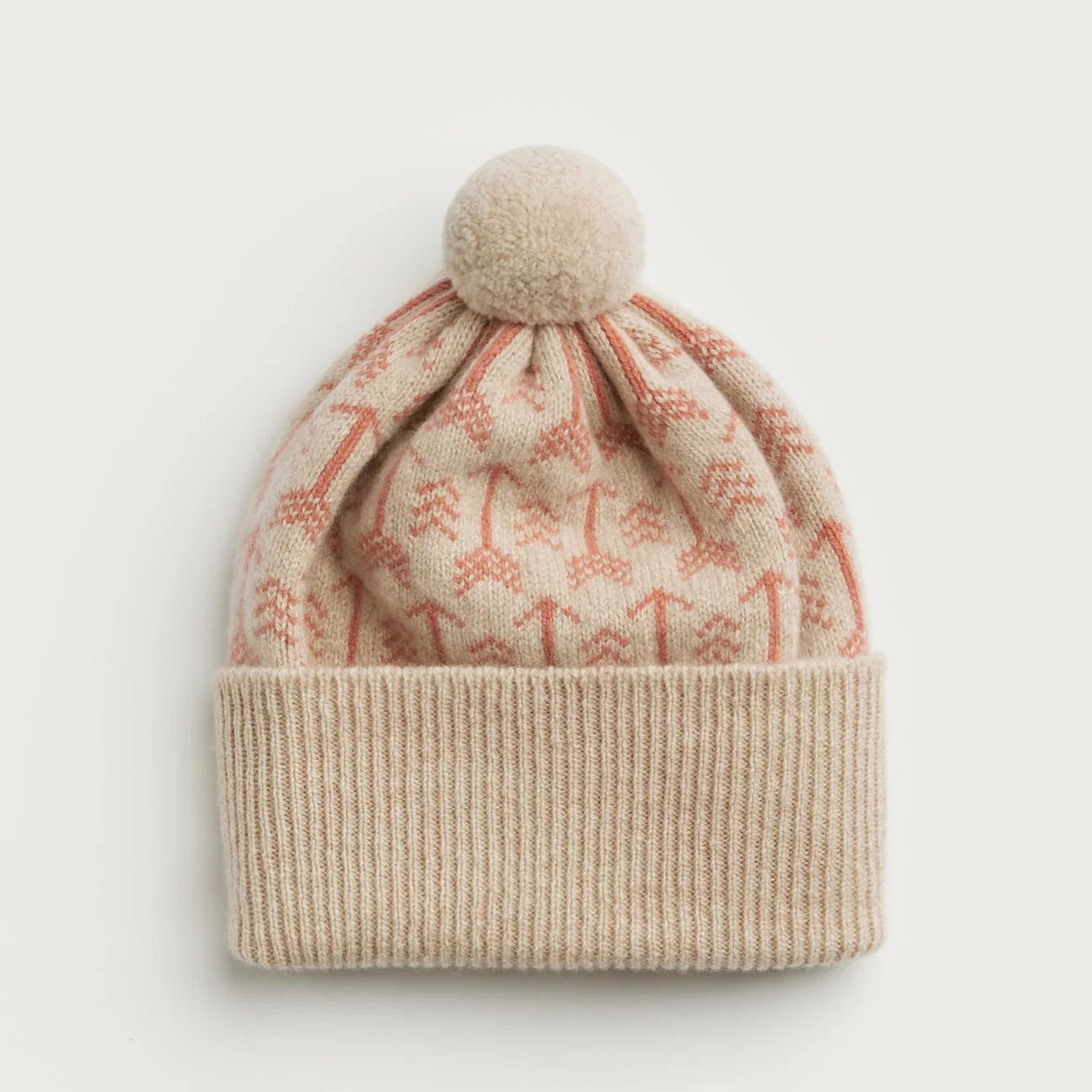Knitted beanie with patterned top and plain bottom on a light gray background