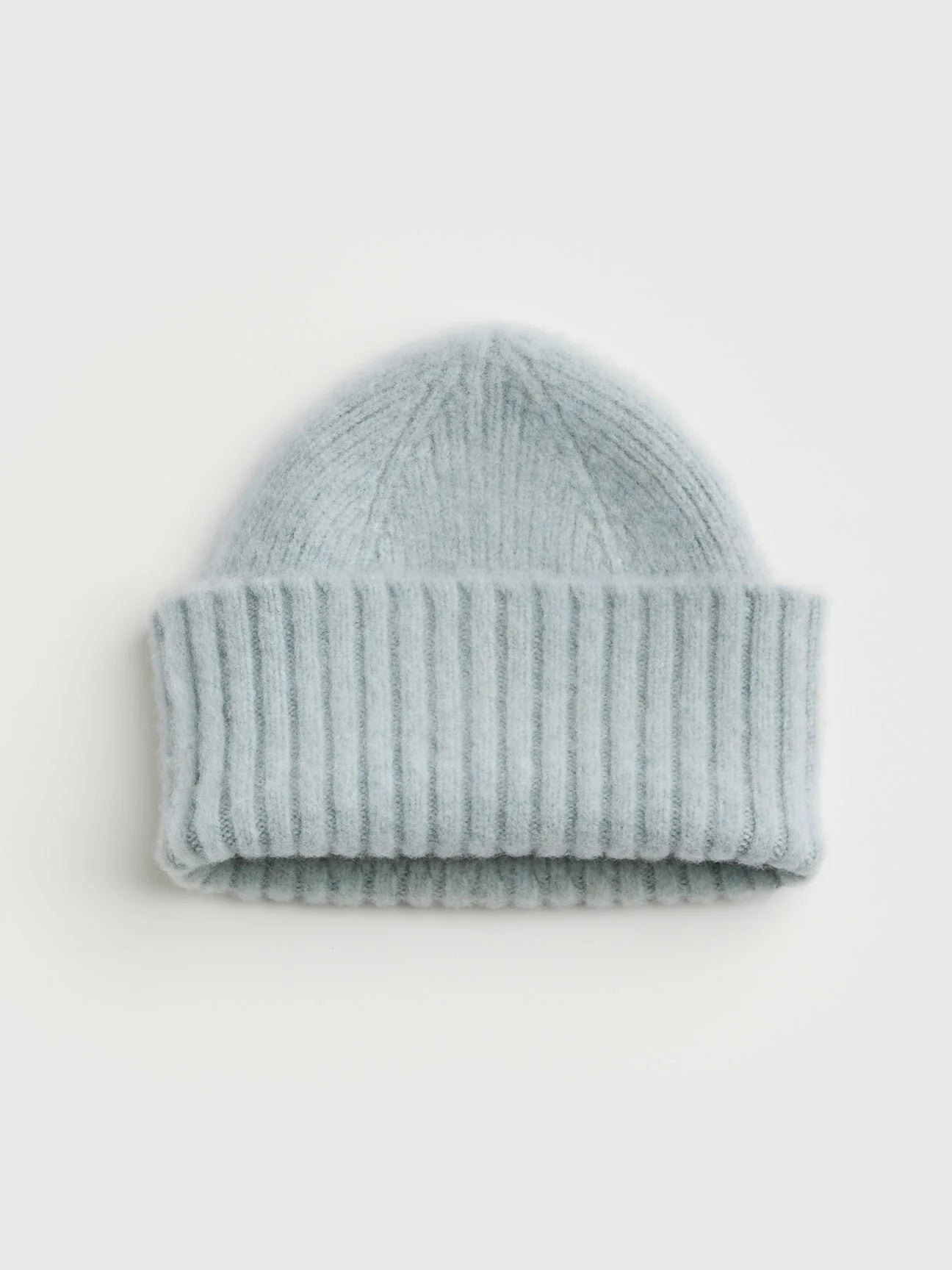 Light blue knit beanie on a white background