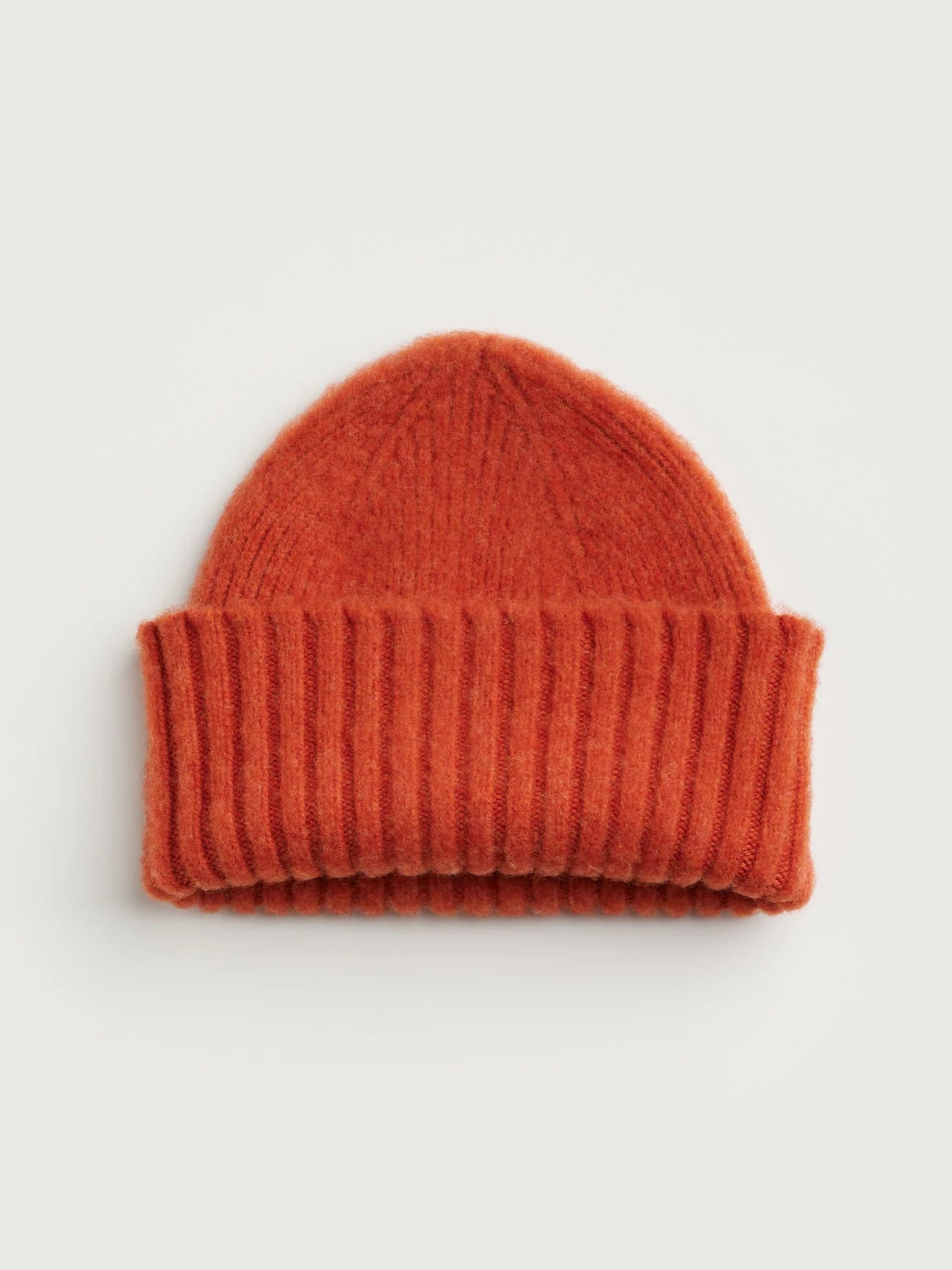 Orange knit beanie on a light gray background