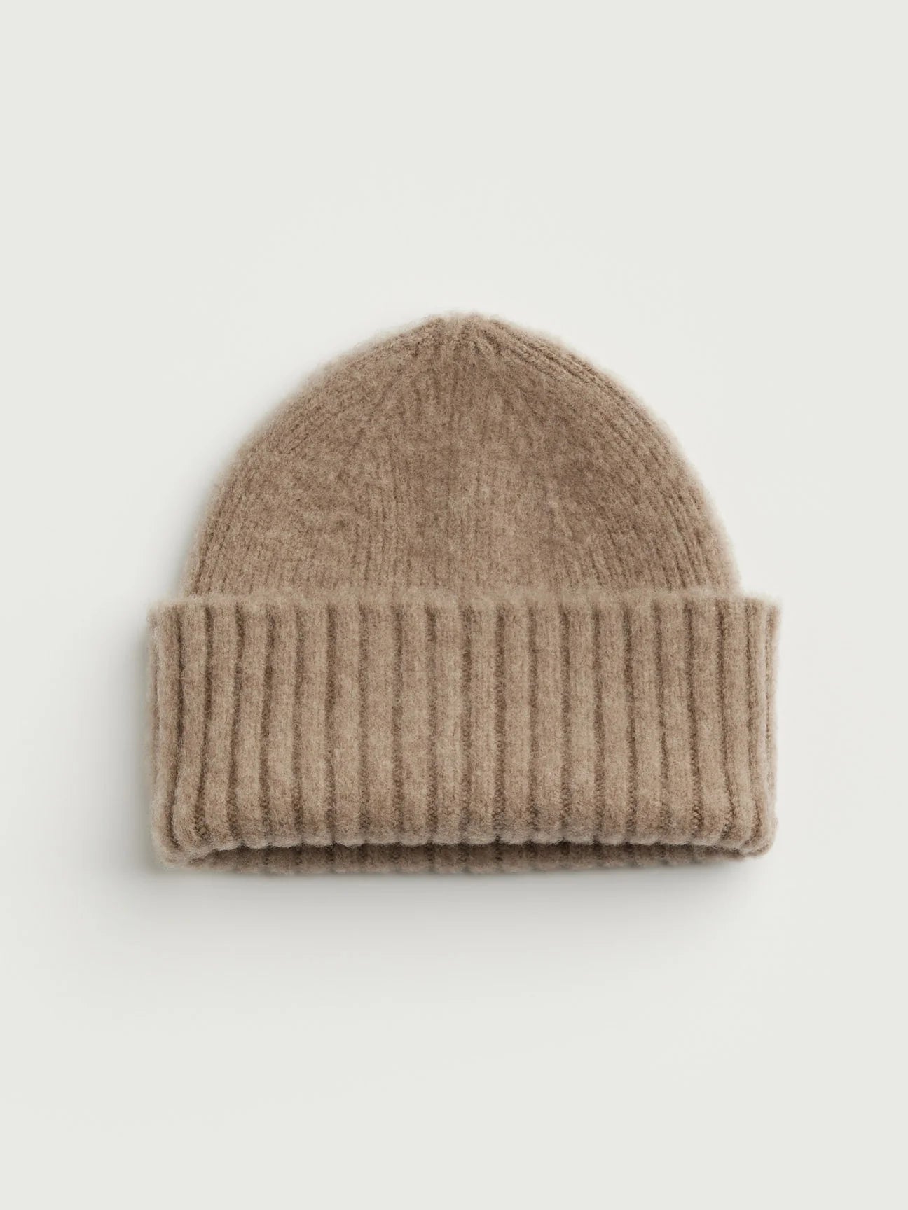 Beige knit beanie on a light gray background