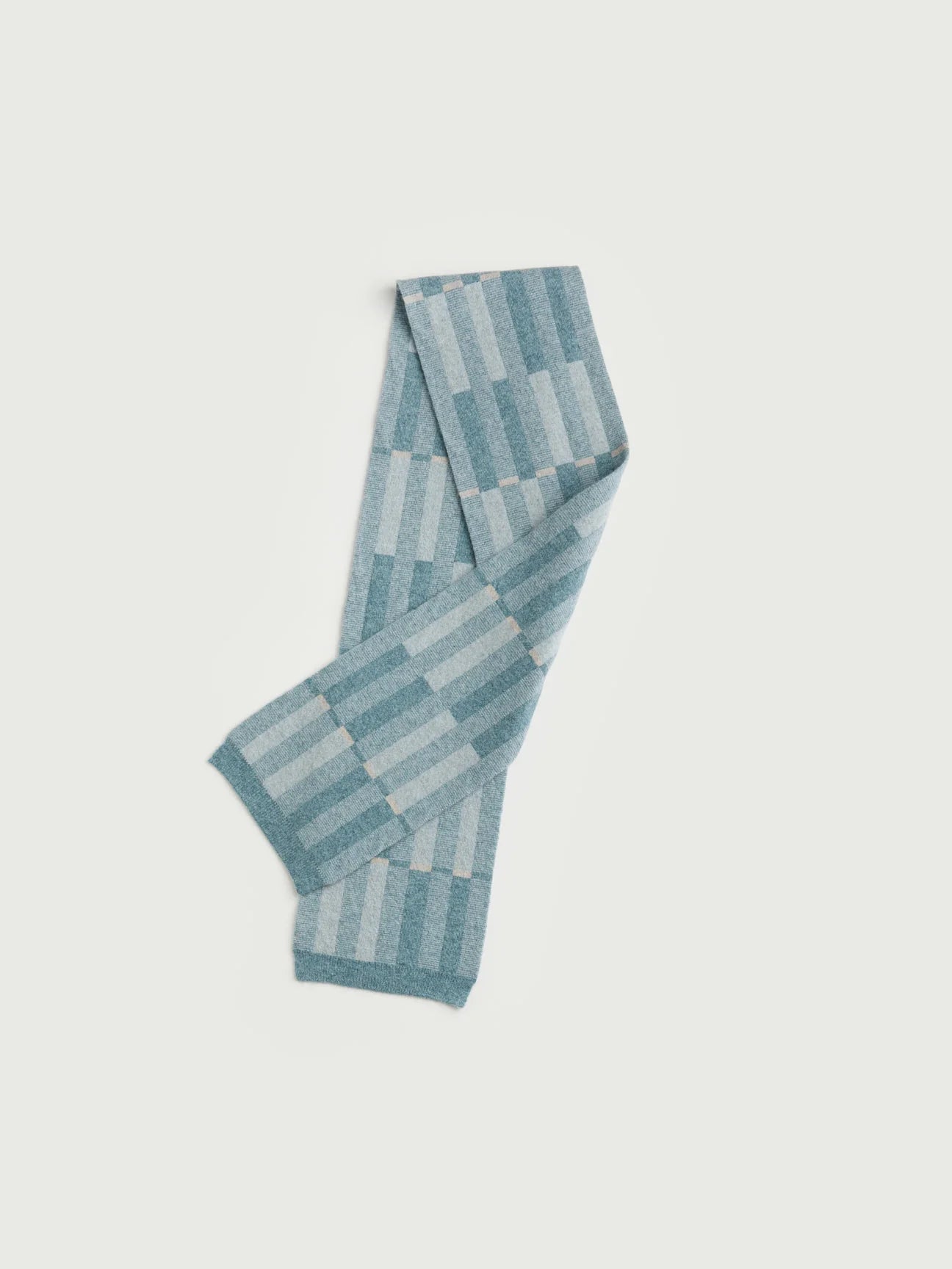 Knitted scarf with a geometric pattern on a light gray background