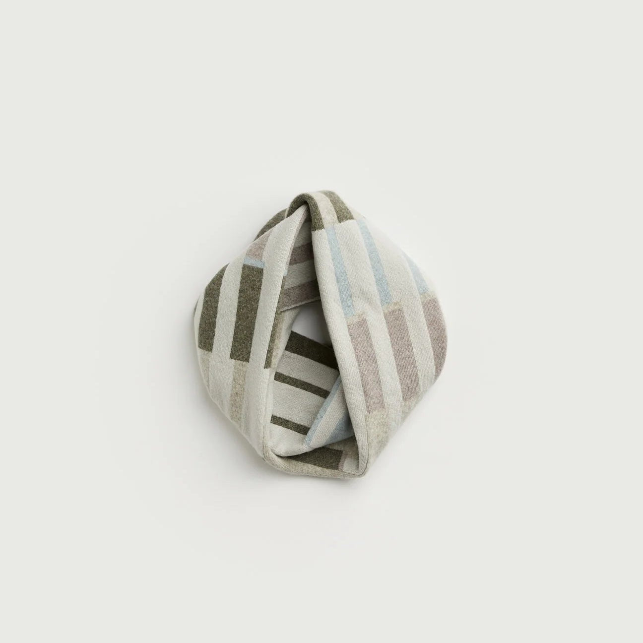 Striped fabric knot on a light gray background